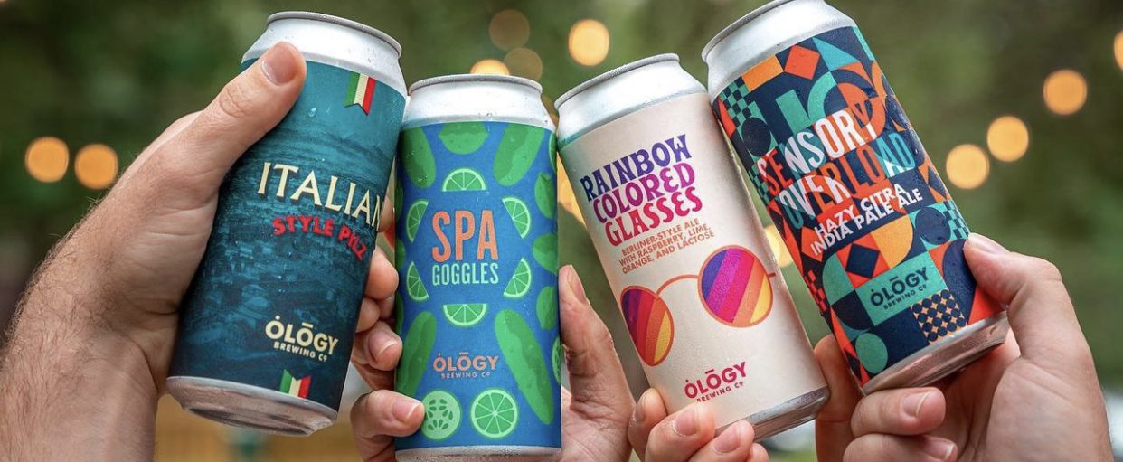 Four friends cheering cans of Ology's core beers; Italian Pilz, Spa Goggles, Rainbow Colored Glasses, and Sensory Overload.
